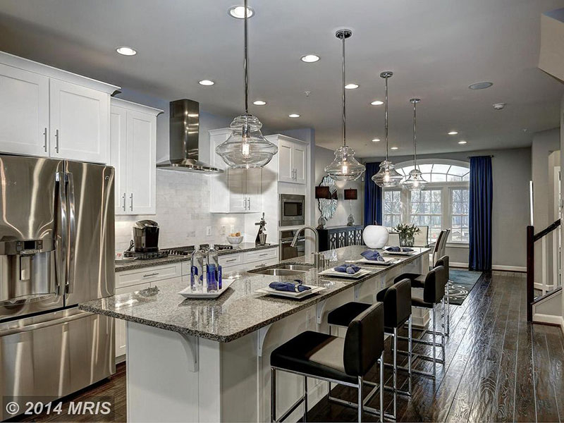 Transitional kitchen with new caledonia granite