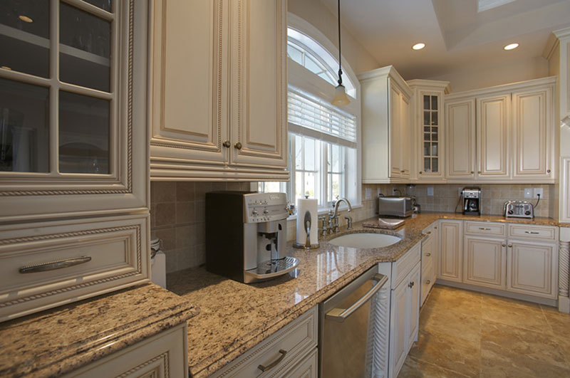 Giallo ornamental granite and white cabinets