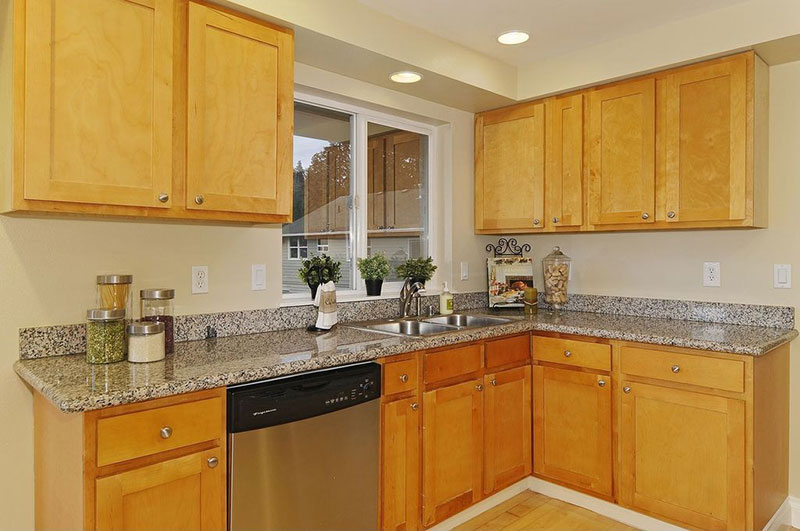 Light wood cabinets with new caledonia granite