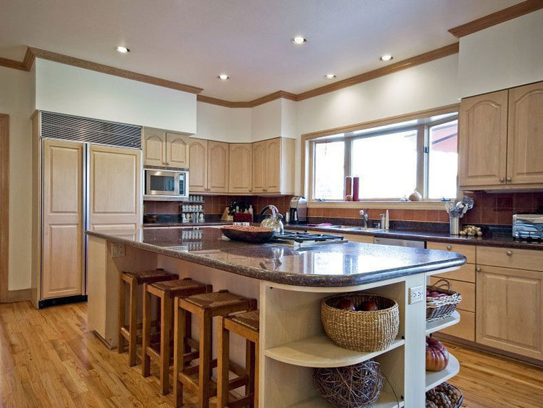 Traditional kitchen with tan brown granite countertops and creams cabinets