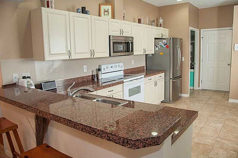 Tan brown granite countertops with white cabinets