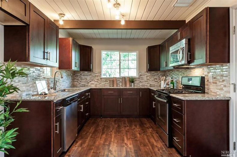 Craftsman kitchen with bianco antico countertops and cherry cabinets