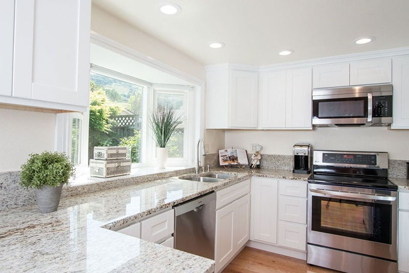 White kitchen with colonial white granite