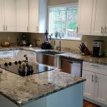 New caledonia granite and white cabinets
