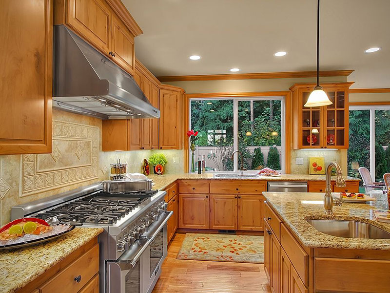 Giallo ornamental granite with honey oak cabinets