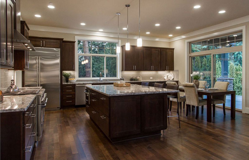 Dark kitchen cabinets with bianco romano granite