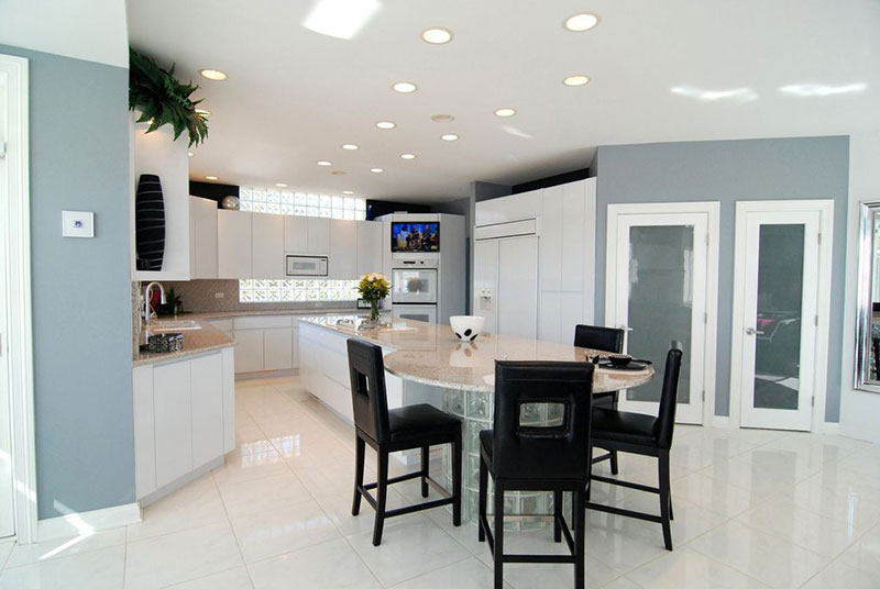 White kitchen with river white granite countertops