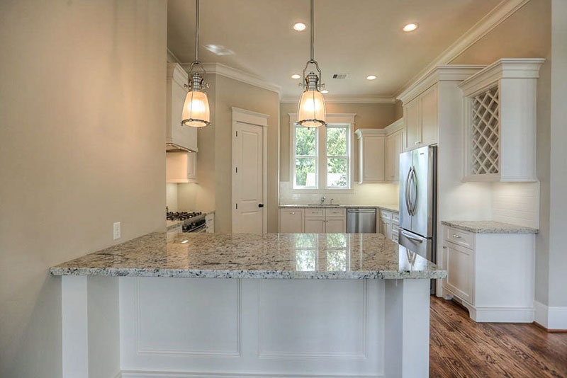 Small white kitchen design with bianco antico countertops