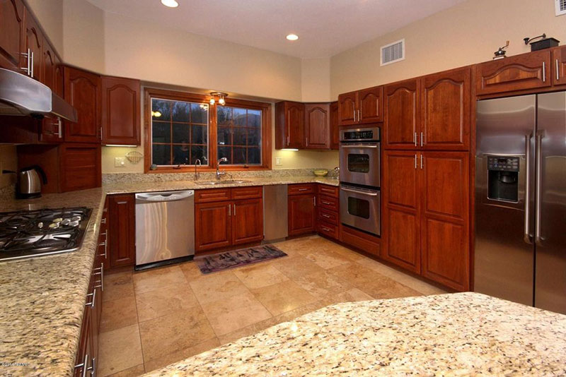 Giallo ornamental granite with brown cabinets