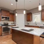 Wood kitchen cabinets with river white granite
