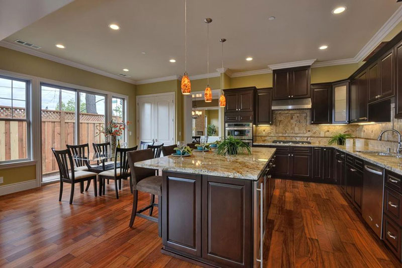 Bianco antico granite with dark cabinets and harwood flooring