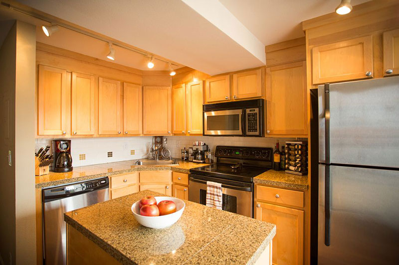 Giallo ornamental granite with light wood cabinets