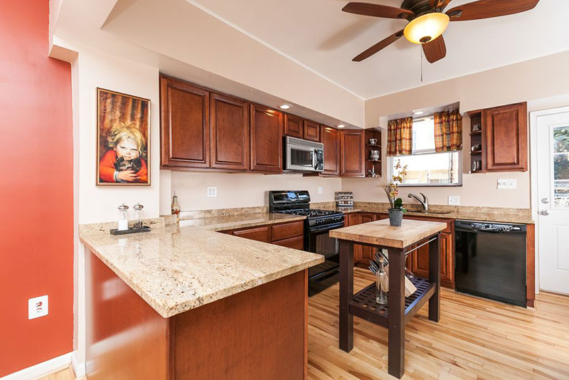 Cherry kitchen cabinets with bianco romano granite