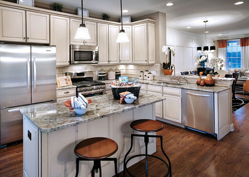 Traditional white kitchen design with bianco antico granite countertops