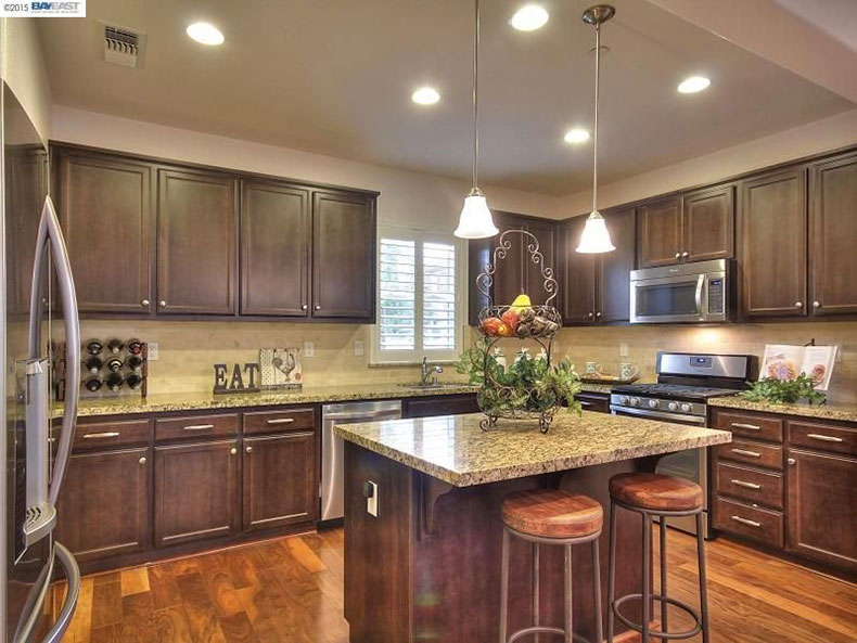 Giallo ornamental granite with dark cabinets