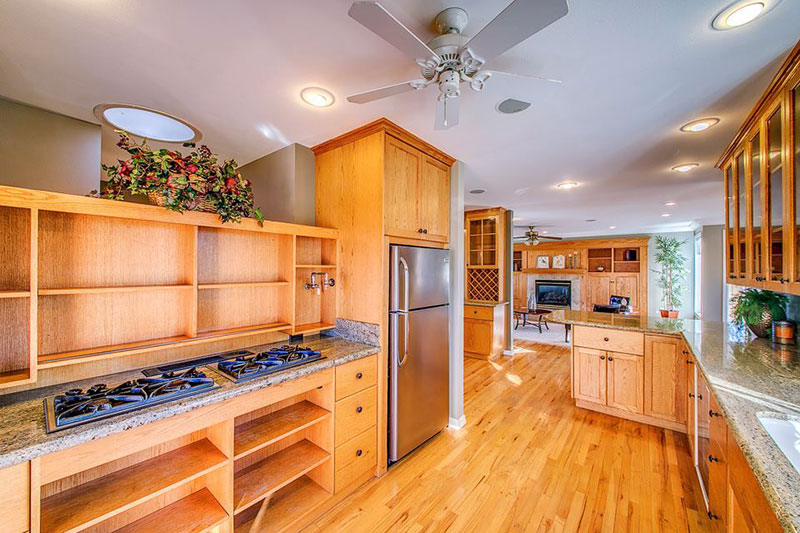 bianco antico granite with oak cabinets and wood flooring