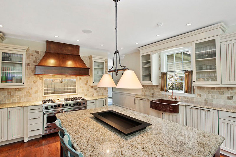 Giallo ornamental granite with antique white cabinets