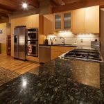 Contemporary kitchen cabinets with uba tuba granite