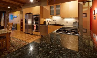 Contemporary kitchen cabinets with uba tuba granite