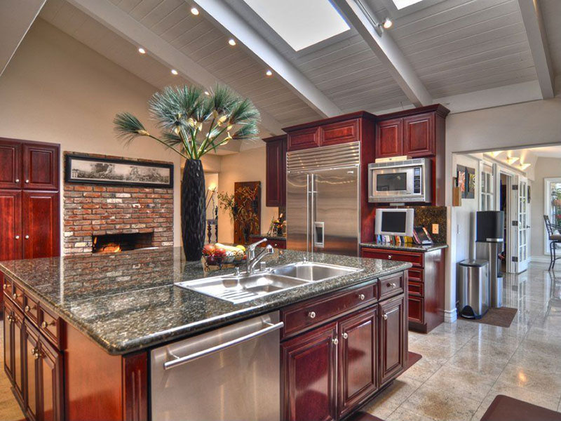 Large kitchen island with uba tuba granite countertops