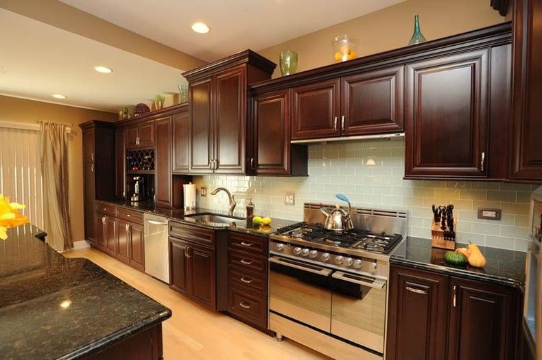 Brown kitchen cabinet with uba tuba granite