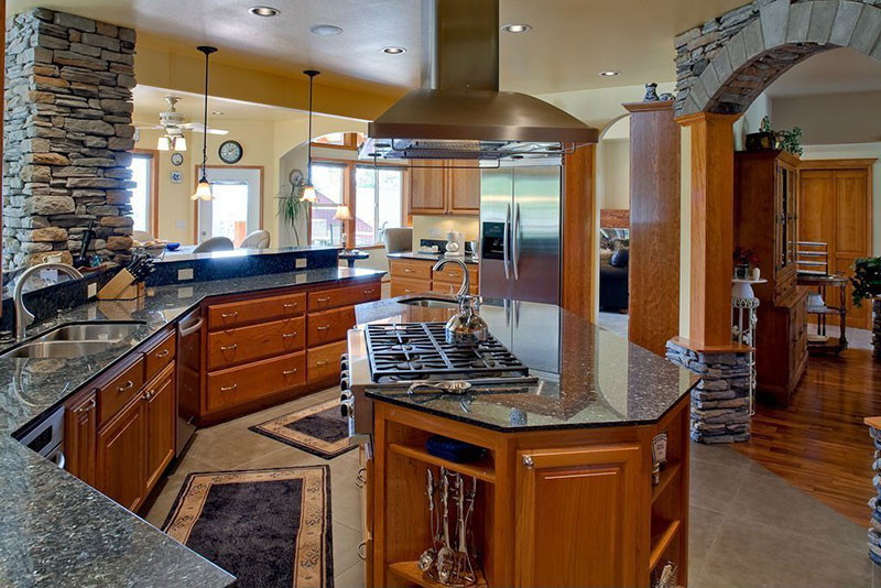 Open plan kitchen with uba tuba granite countertops