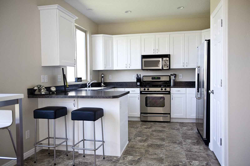 Black granite with white kitchen cabinets