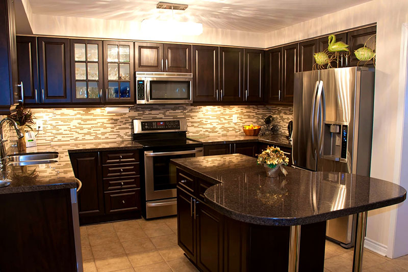 Black granite with black kitchen cabinets