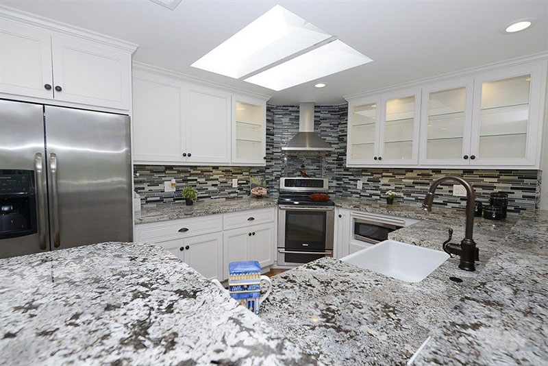 Alaska white granite countertops with subway tile backsplash