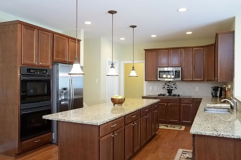 Alaskan white granite with brown cabinets